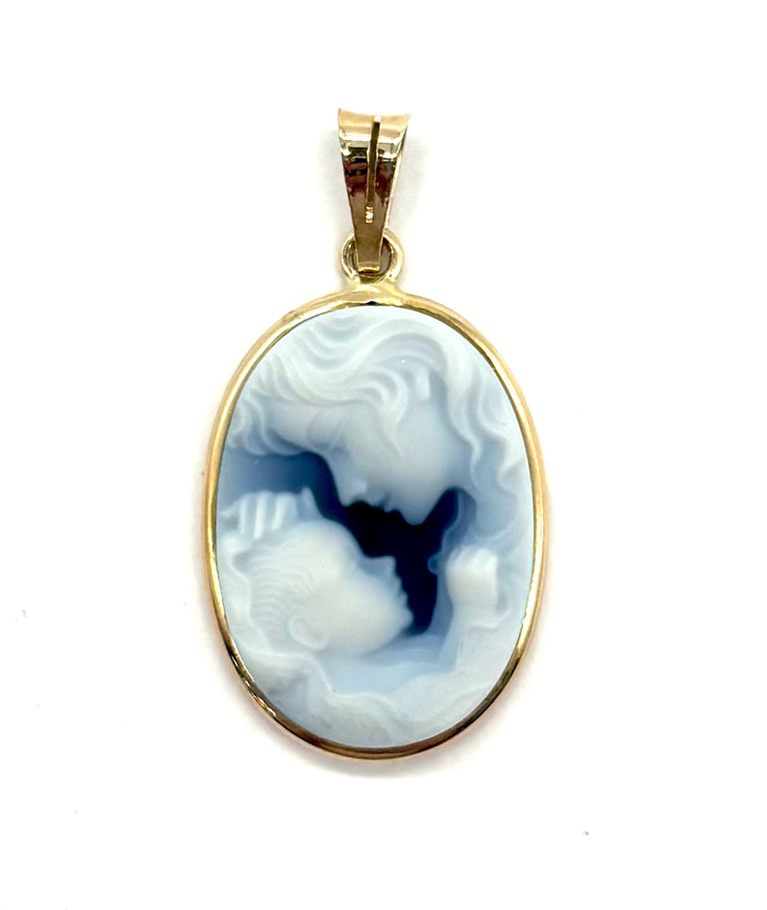 Gold pendant with a blue and white stone on a white background