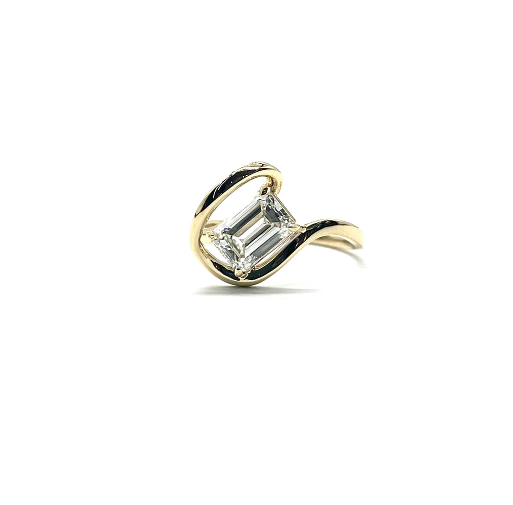 Gold ring with a diamond on a white background