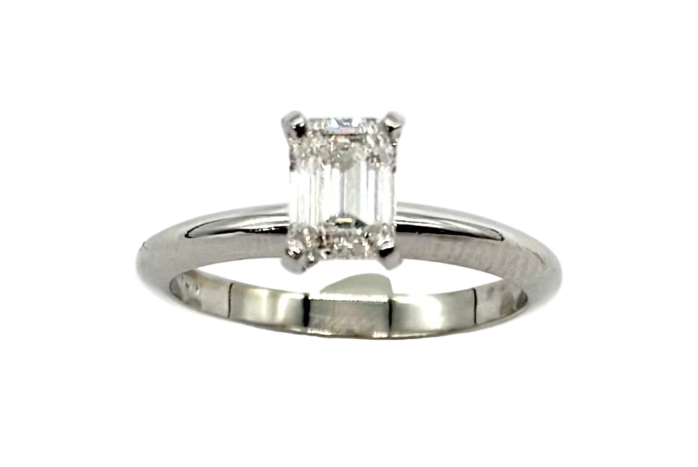 Silver ring with a rectangular diamond on a white background