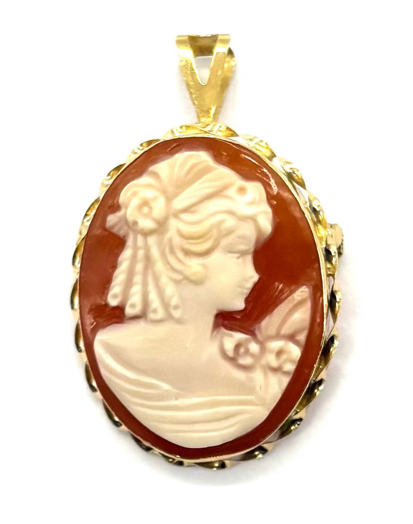 Gold pendant with a classical profile design on a white background