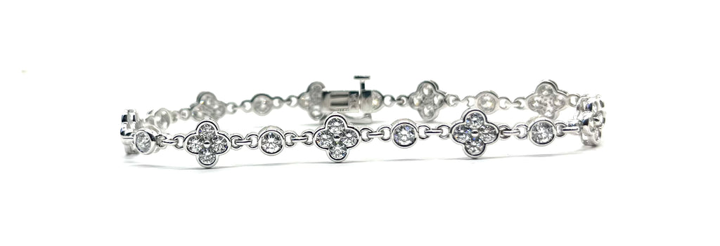 Silver bracelet with floral designs on a white background