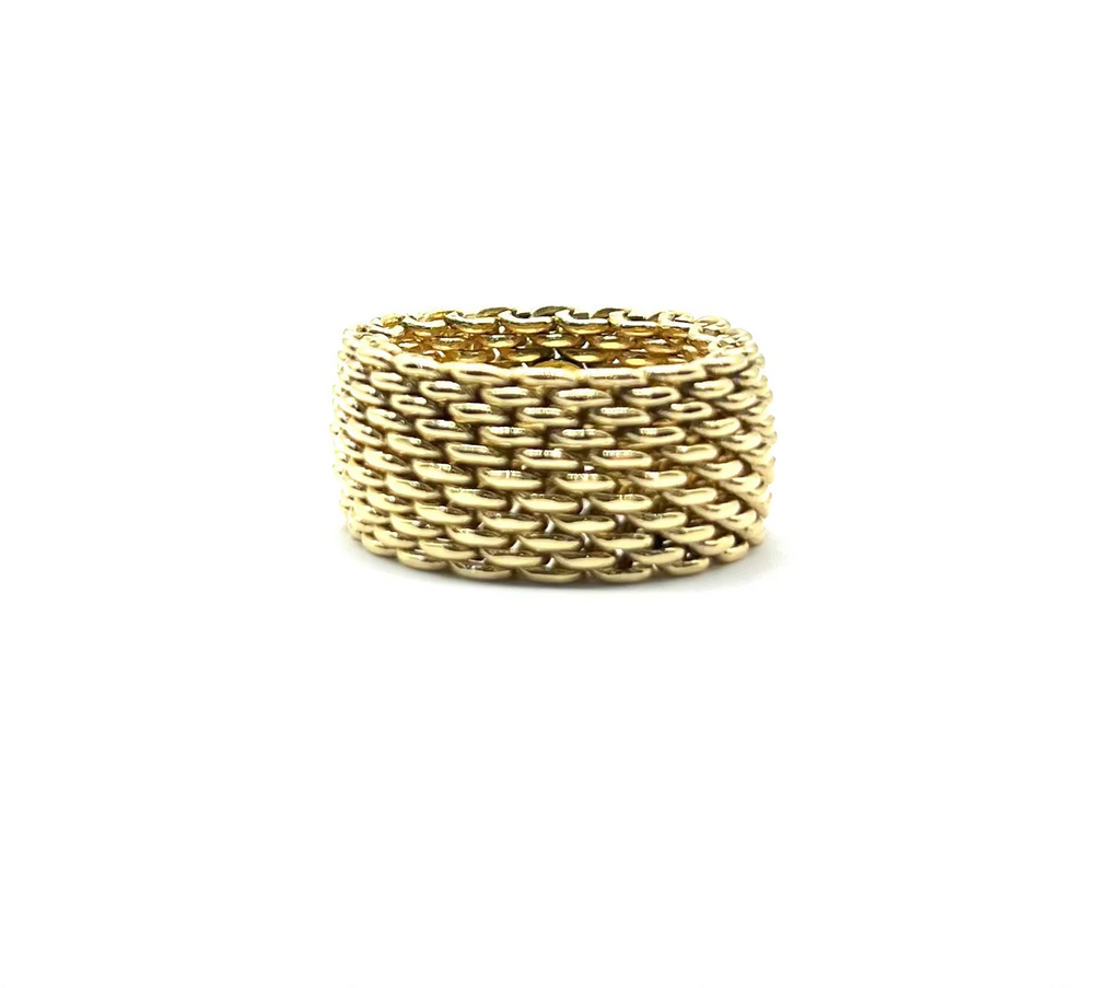 Gold braided ring on a white background