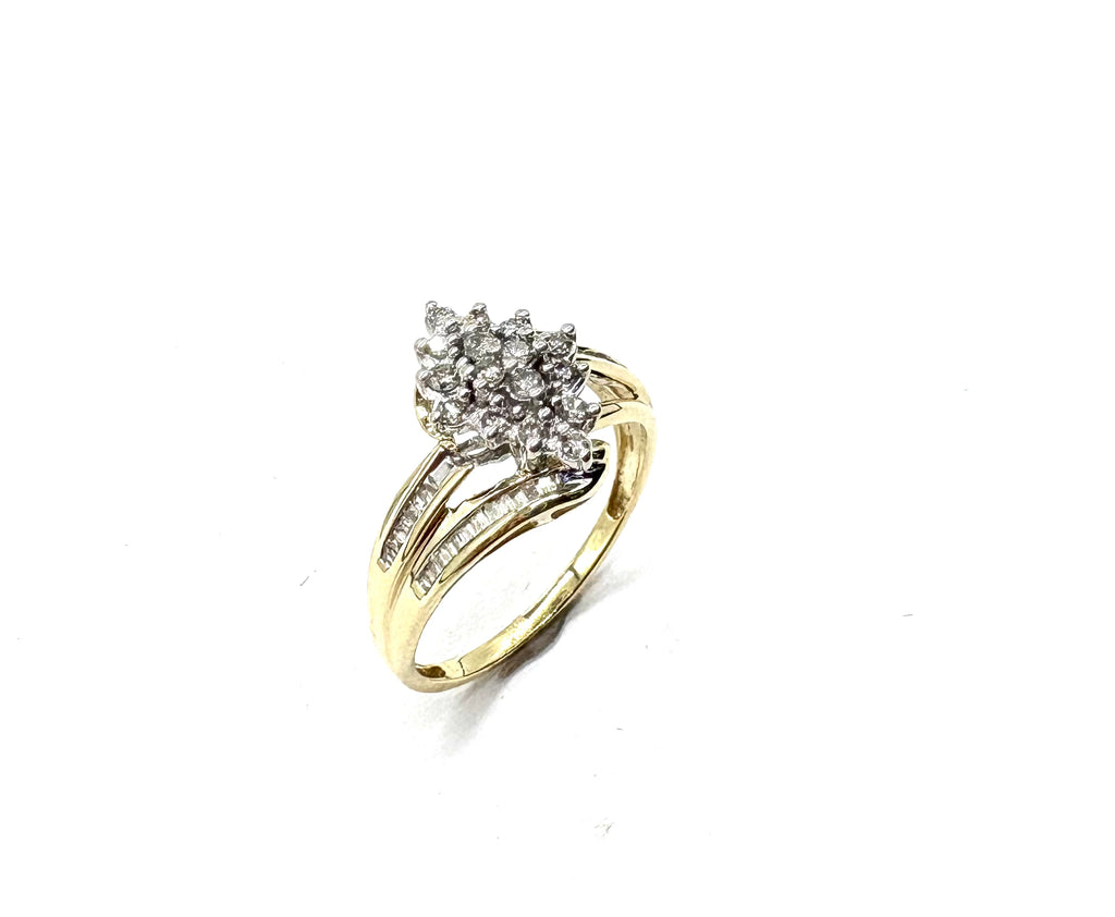 Gold ring with diamond cluster on a white background