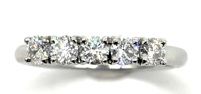 Diamond ring with five stones on a white background