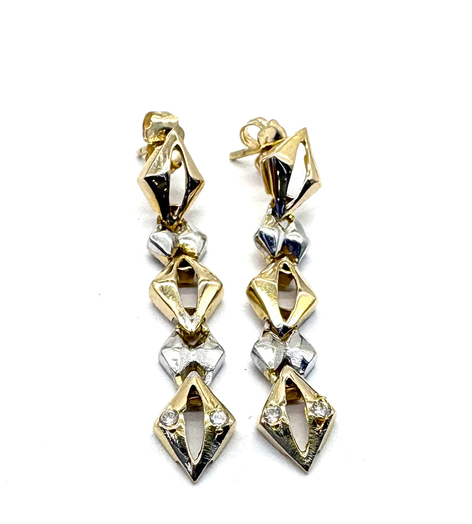Gold and silver diamond-shaped earrings on a white background