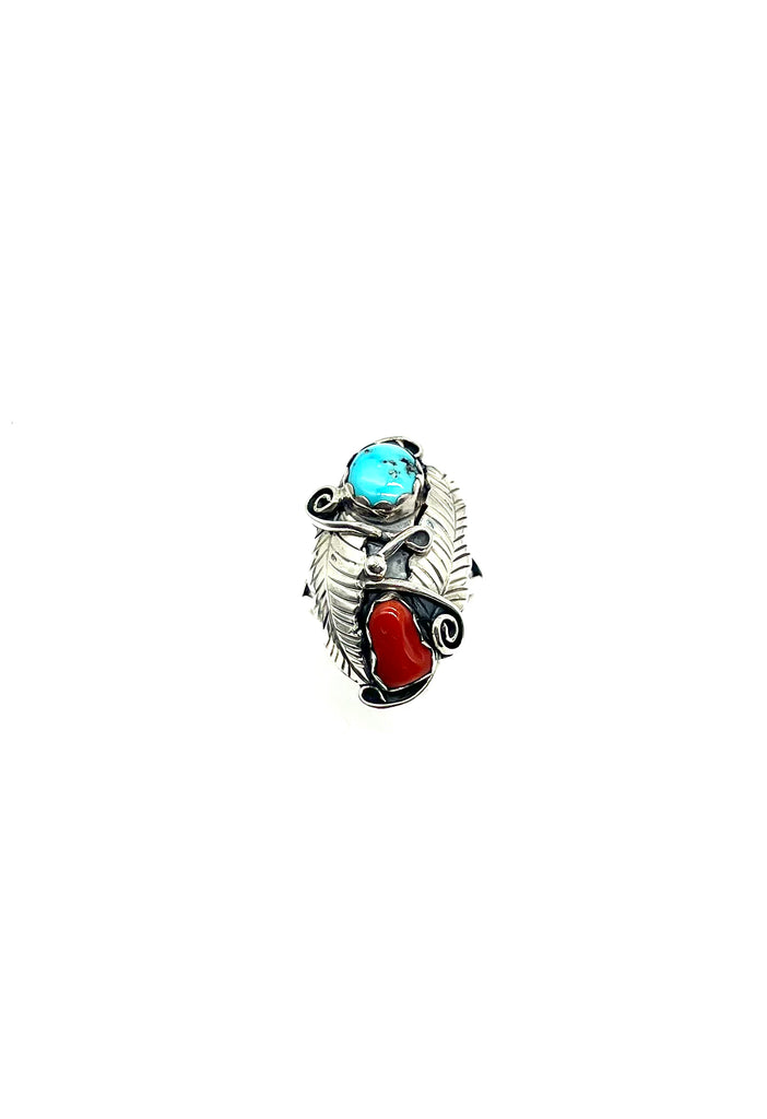 Silver ring with turquoise and red stone on a white background