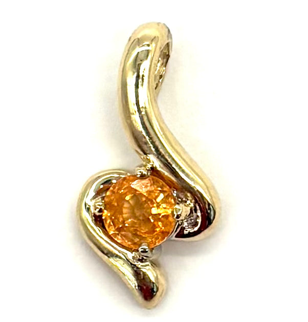 Gold pendant with a yellow gemstone on a white background