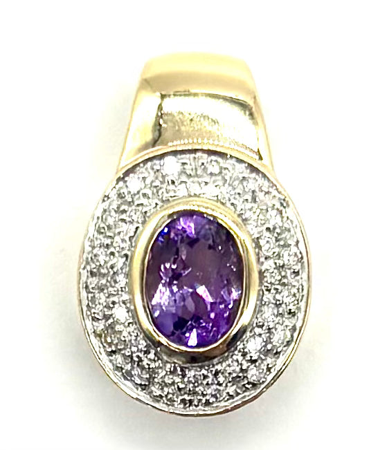Gold ring with a purple gemstone and diamond-studded band on a white background