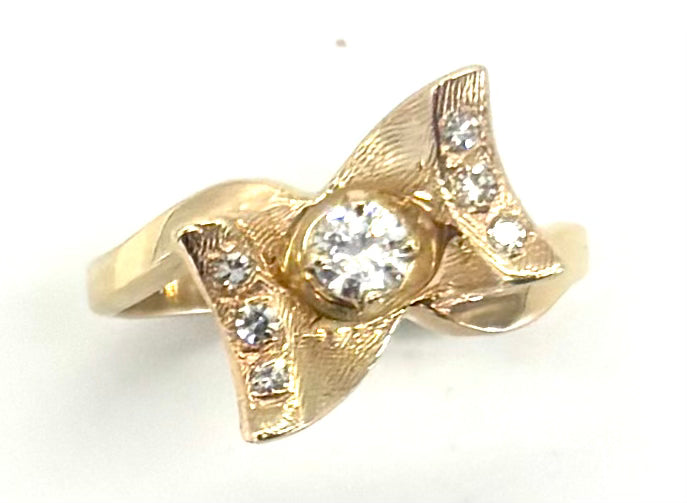 Gold ring with a diamond on a white background