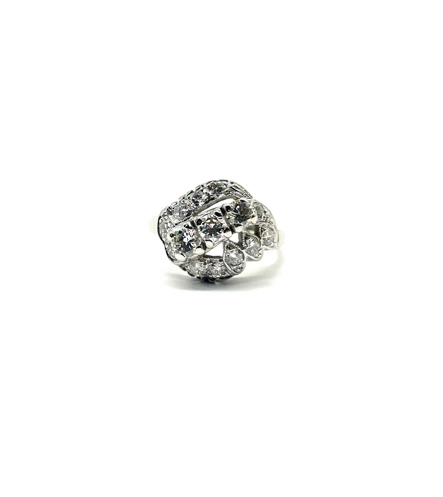 Silver ring with clear gemstones on a white background