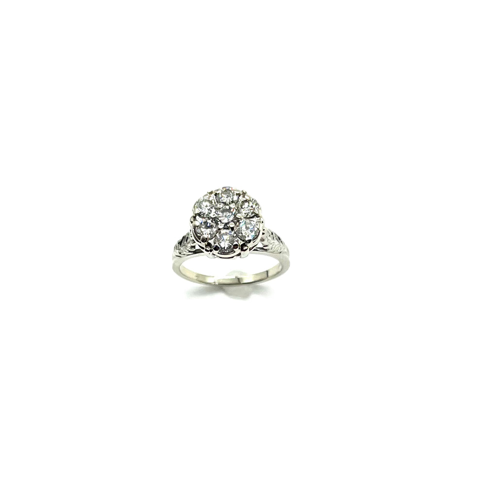 Silver ring with a diamond cluster on a white background
