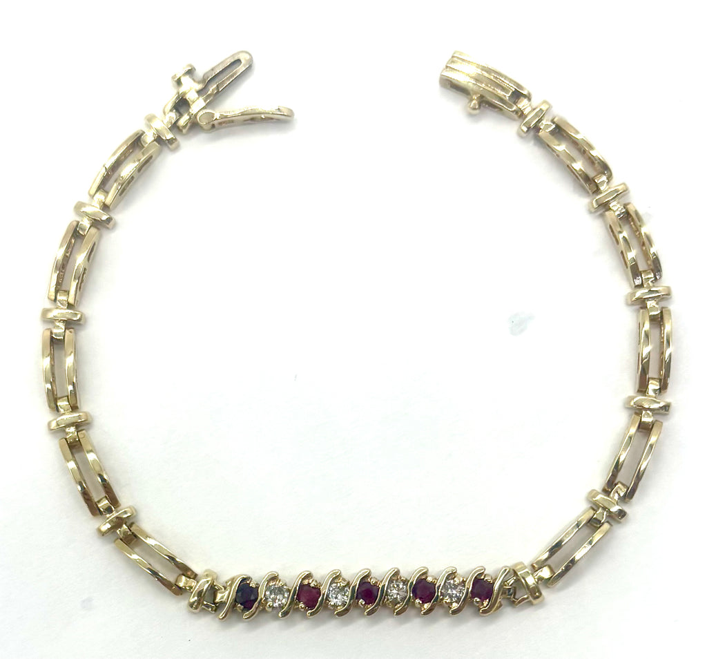 Gold bracelet with embedded gemstones on a white background