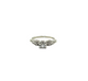 Gold ring with a green gemstone and diamond accents on a white background
