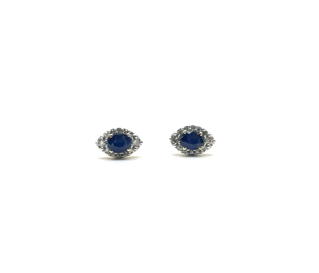 Pair of silver earrings with blue gemstones on a white background