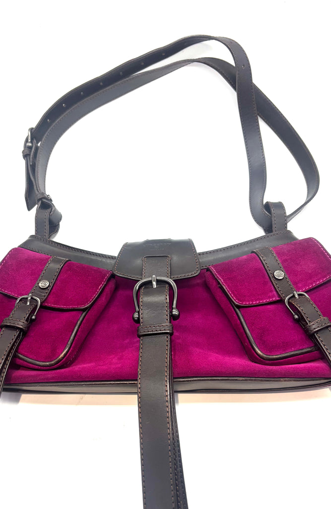 Purple handbag with black straps on a white background