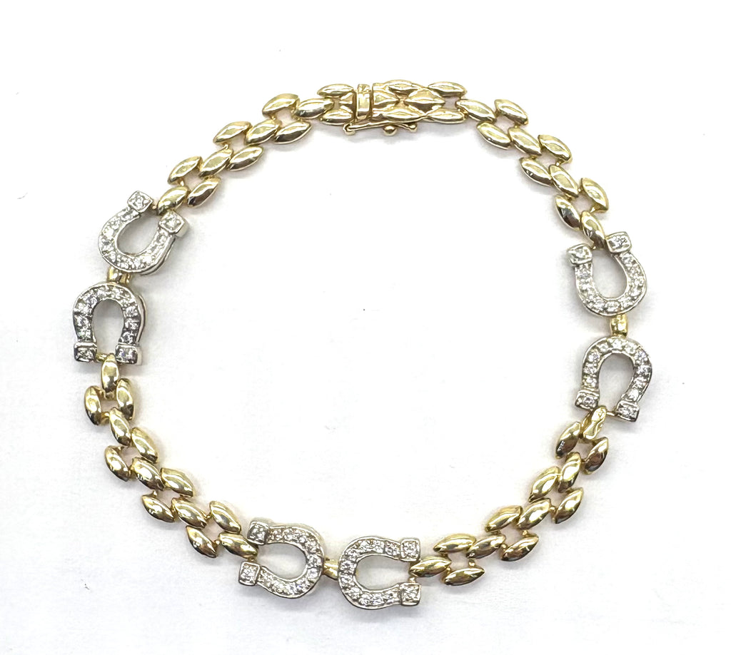 Gold bracelet with horse shoe designs on a white background