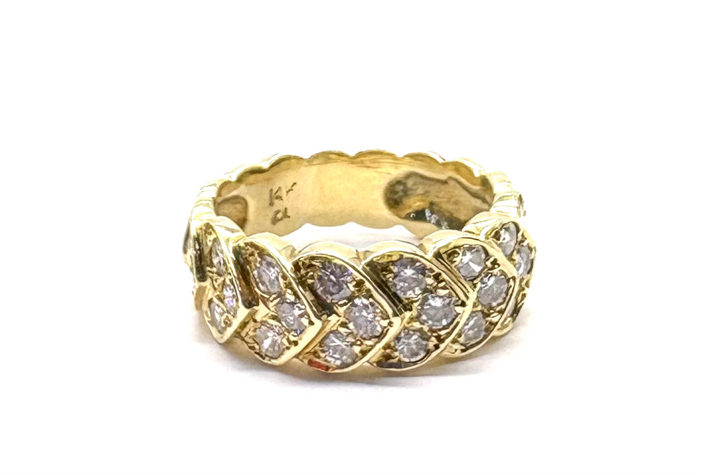 Gold ring with diamond accents on a white background