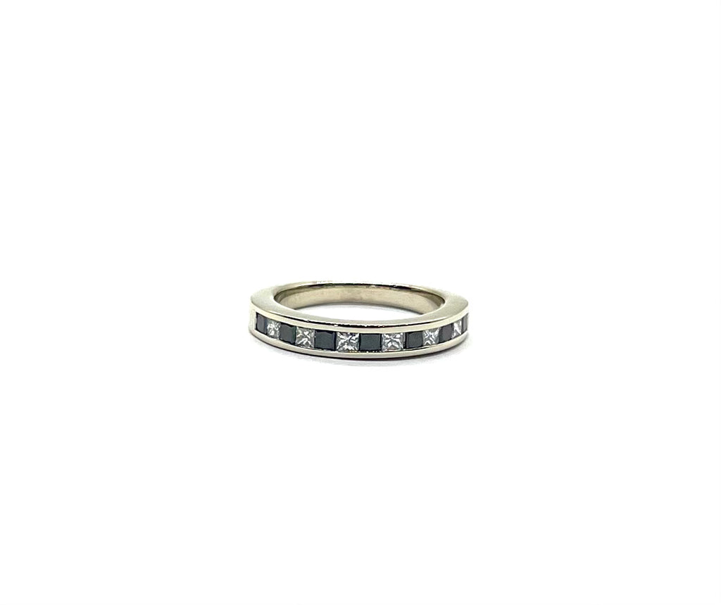 Silver ring with embedded stones on a white background