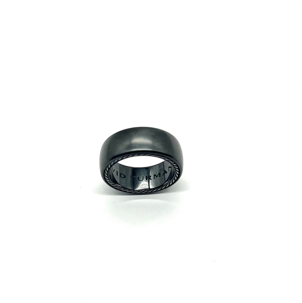 Black ring with engraved text on a white background