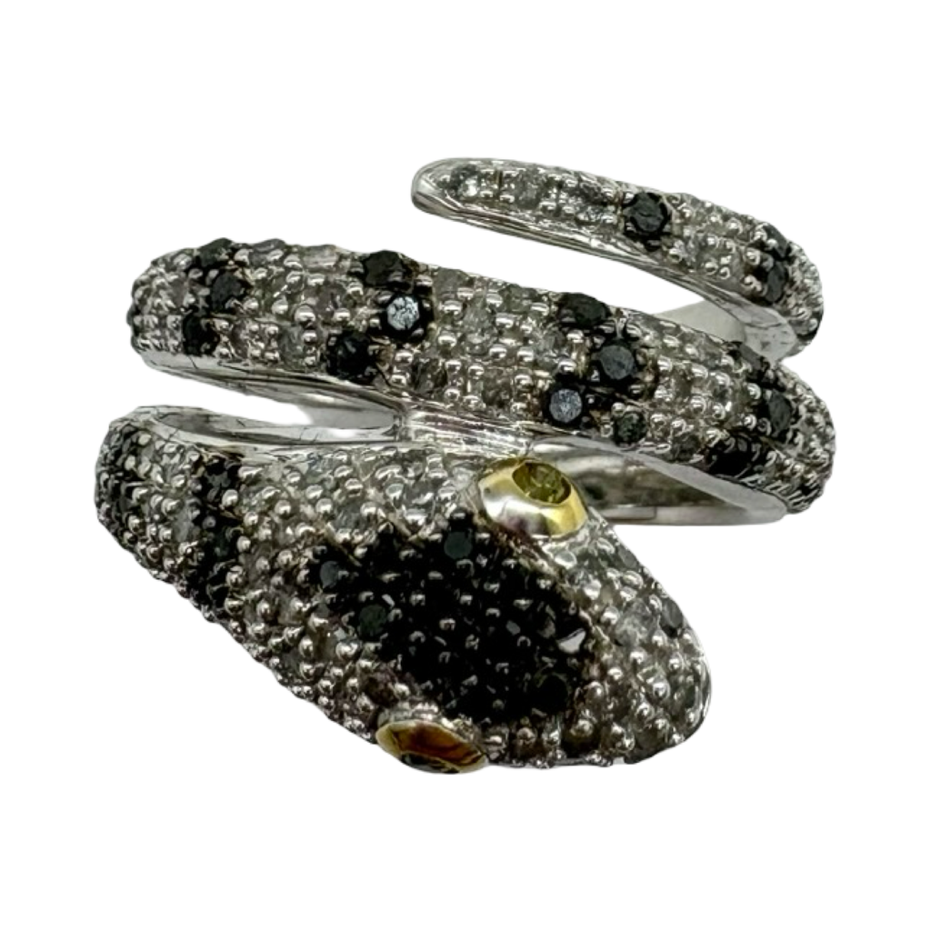 Silver snake-shaped ring with black and clear gemstones on a white background