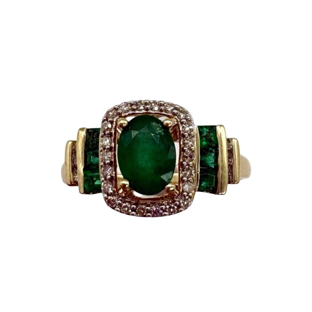 Gold ring with a green gemstone on a white background