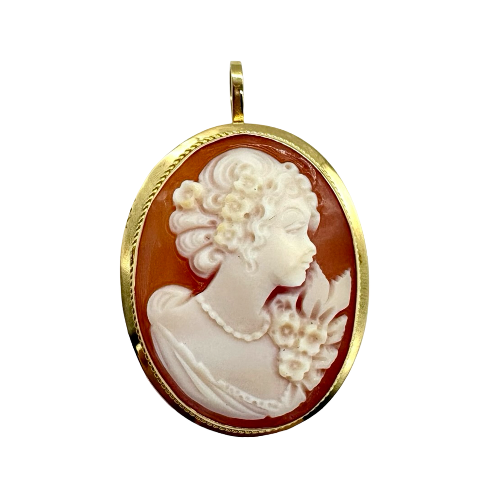 Cameo pendant with a gold frame on a white background