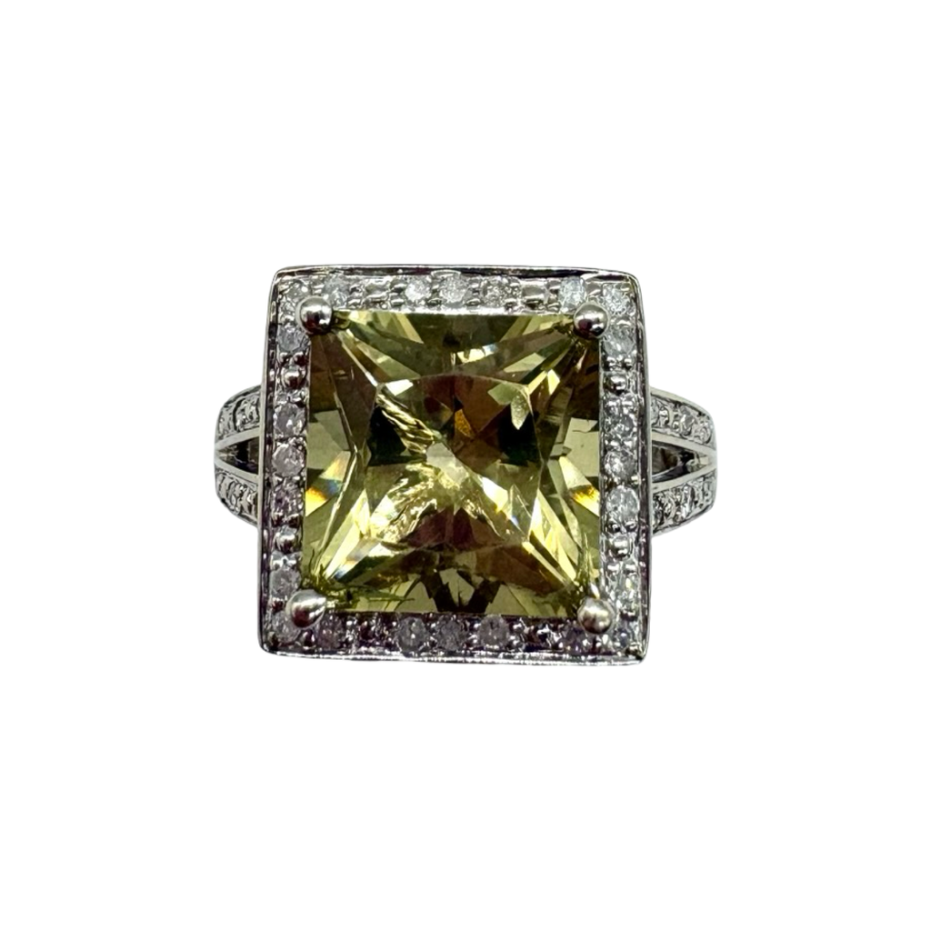 Ring with a large yellow gemstone and smaller diamonds on a white background