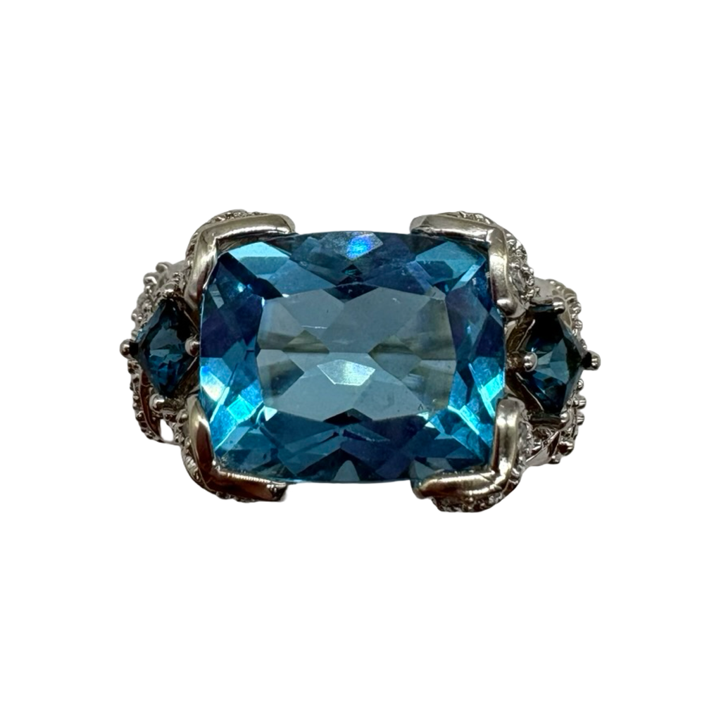 Silver ring with a large blue gemstone on a white background