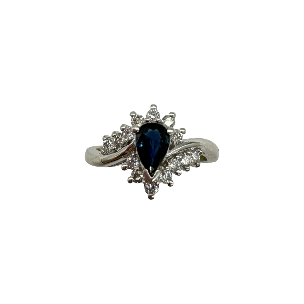 Silver ring with a blue gemstone and diamond accents on a white background