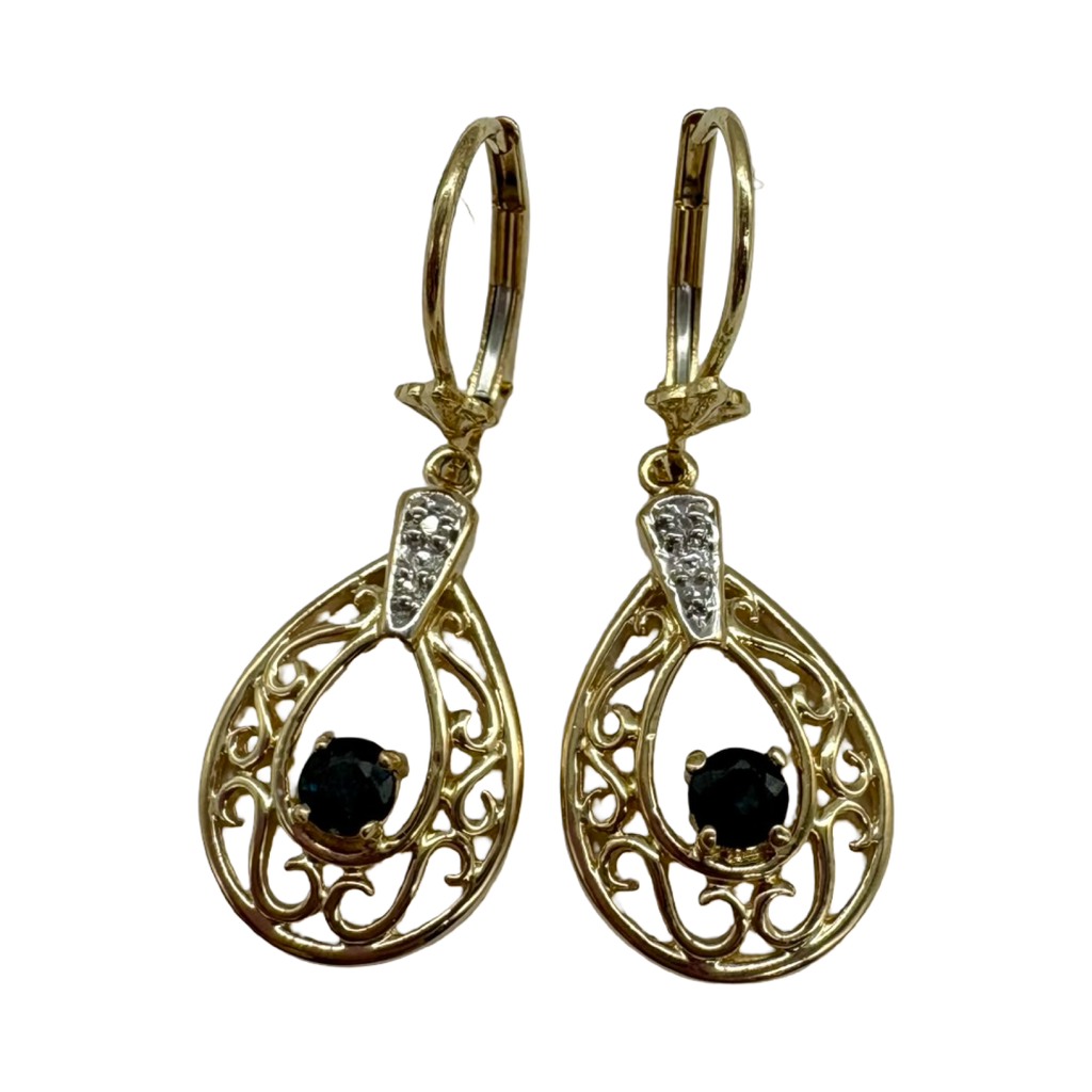 Gold earrings with black gemstones on a white background