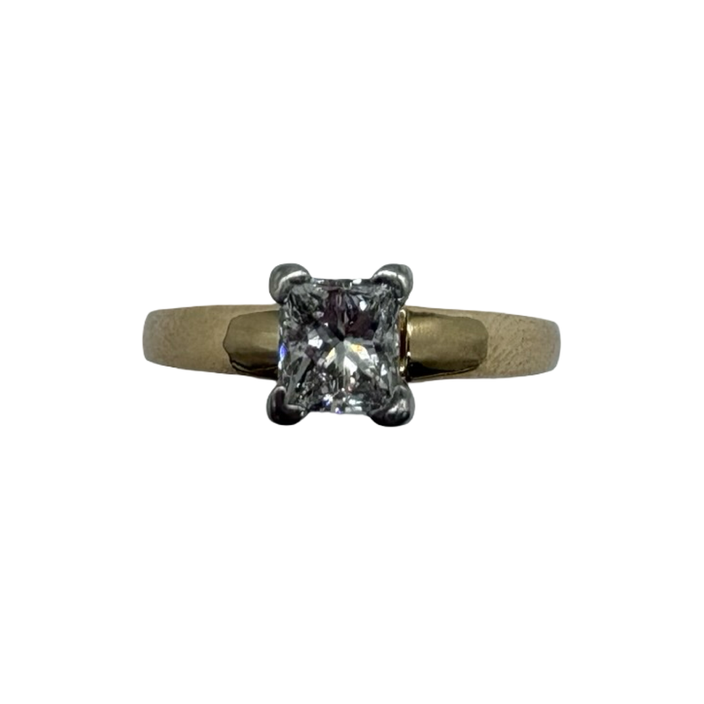 Gold ring with a diamond on a white background