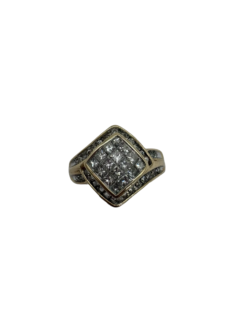 Gold ring with diamond-like stones on a white background