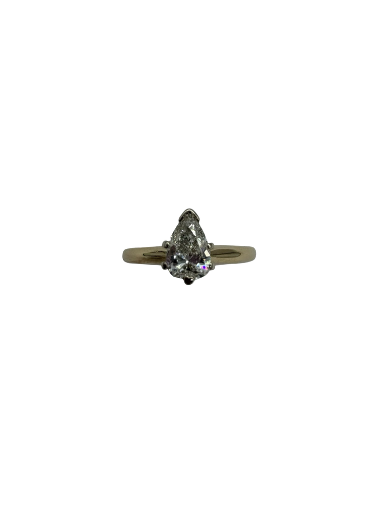 Pear-shaped diamond ring on a white background
