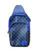 Checkered sling bag with blue accents on a wooden surface