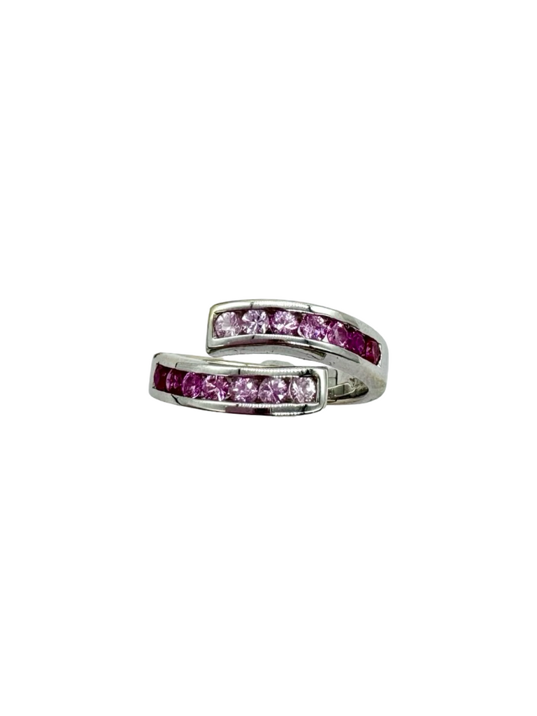 Silver ring with pink gemstones on a white background