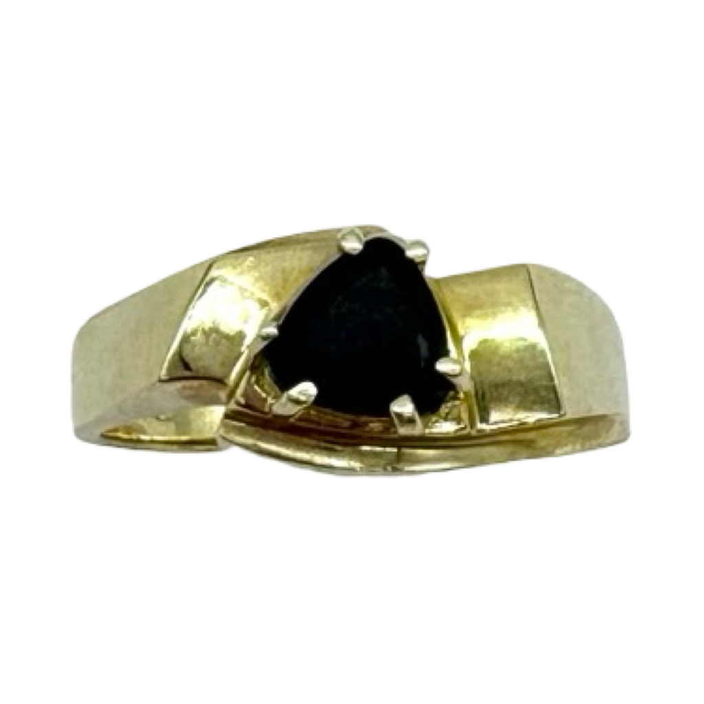 Gold ring with a black gemstone on a white background