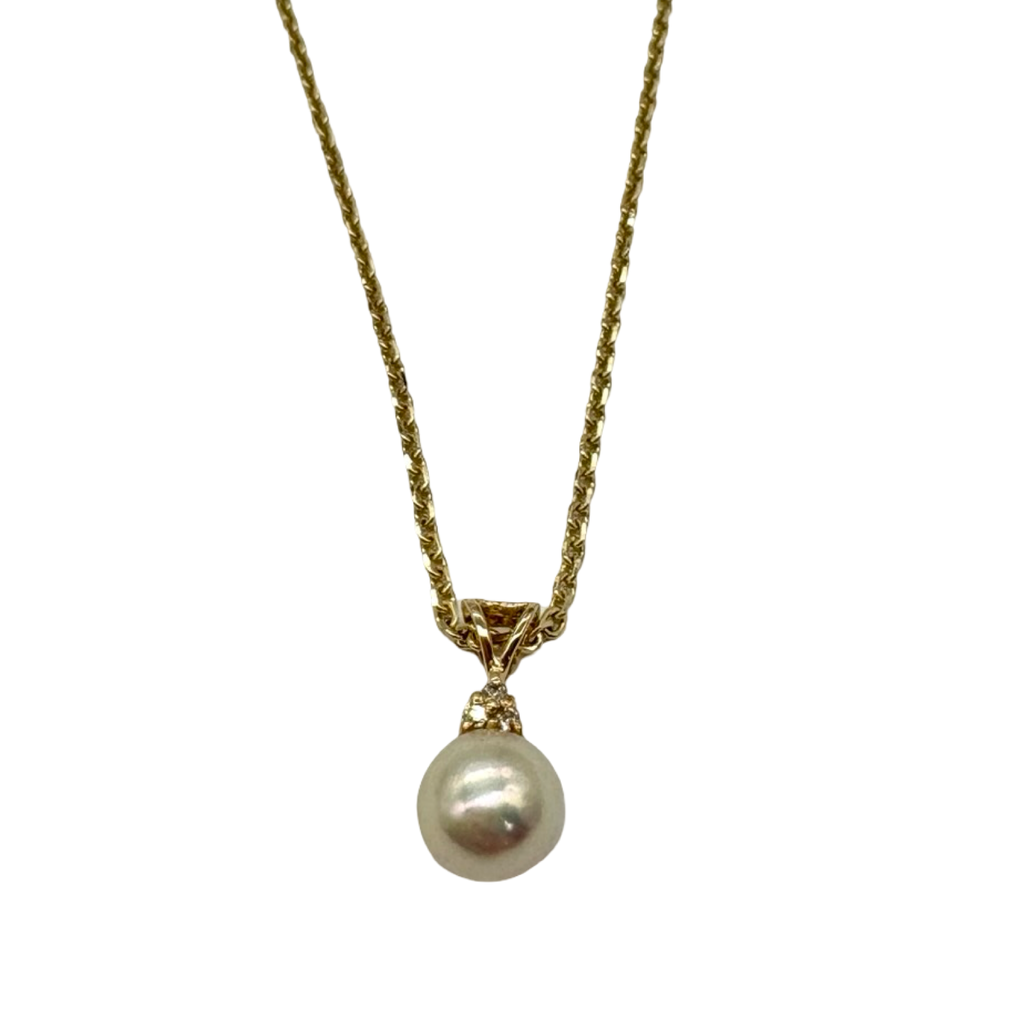 Pearl necklace with gold chain on a white background