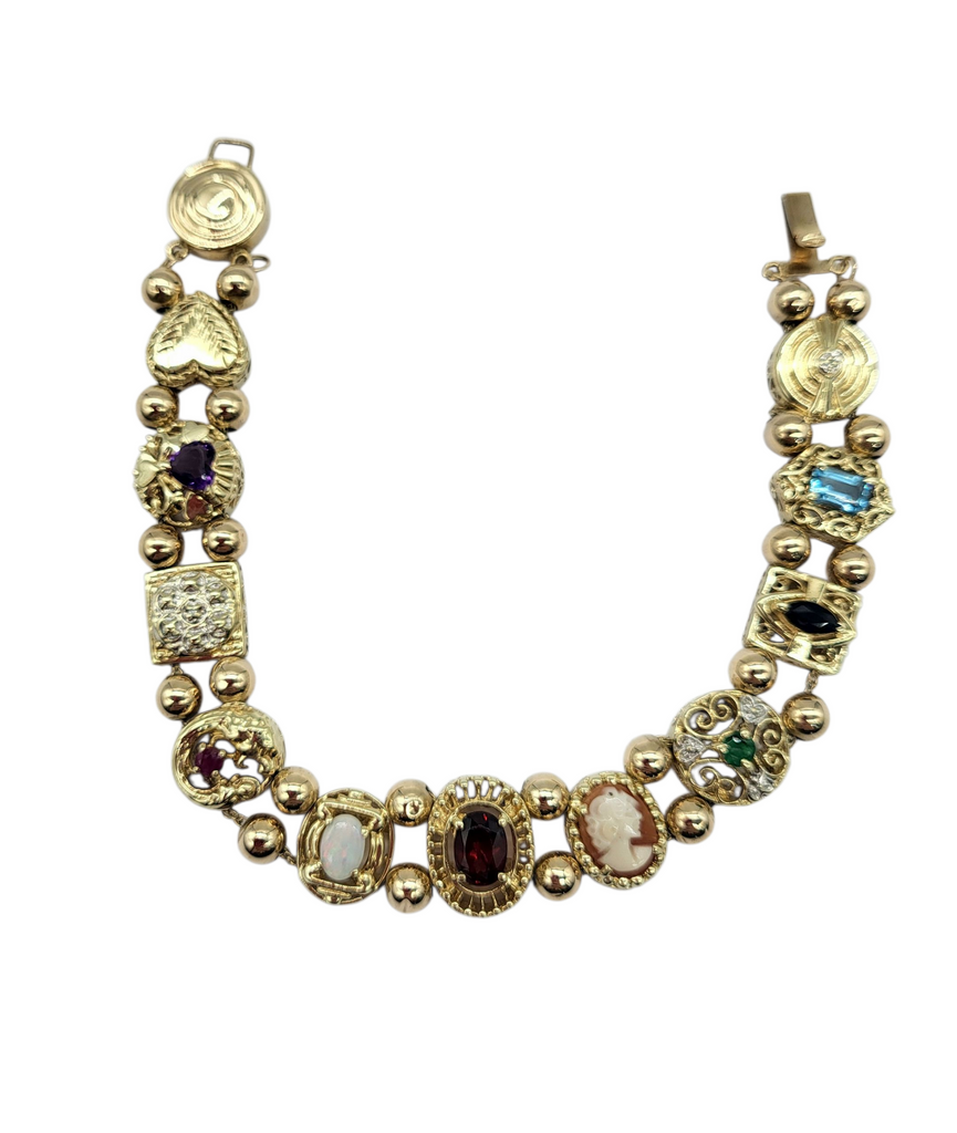 Gold bracelet with various gemstones on a white background