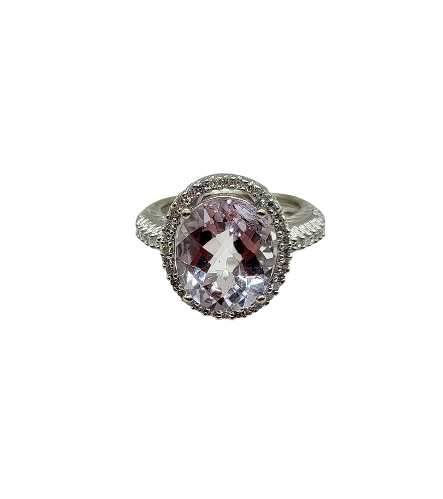 Silver ring with a pink gemstone on a white background
