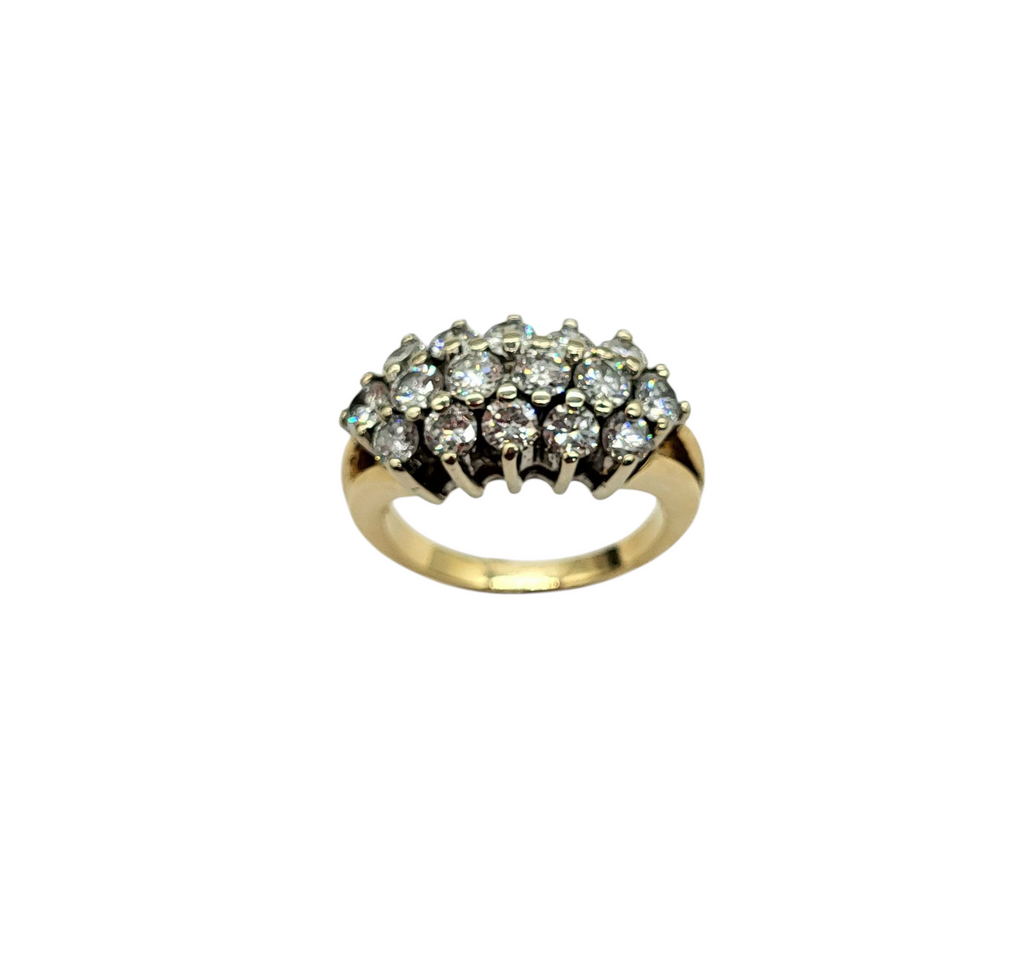 Gold ring with diamond cluster on a white background