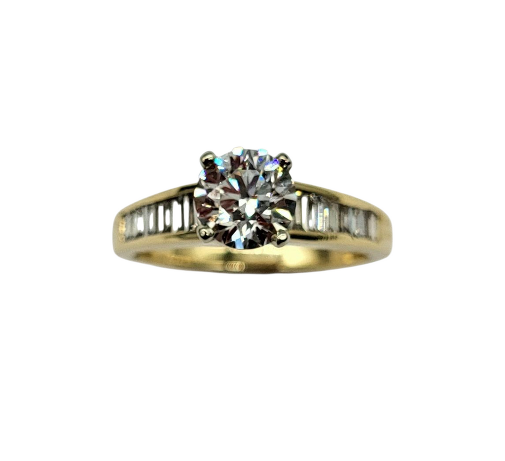 Gold ring with a diamond on a white background