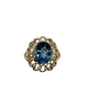 Gold ring with a blue gemstone on a white background