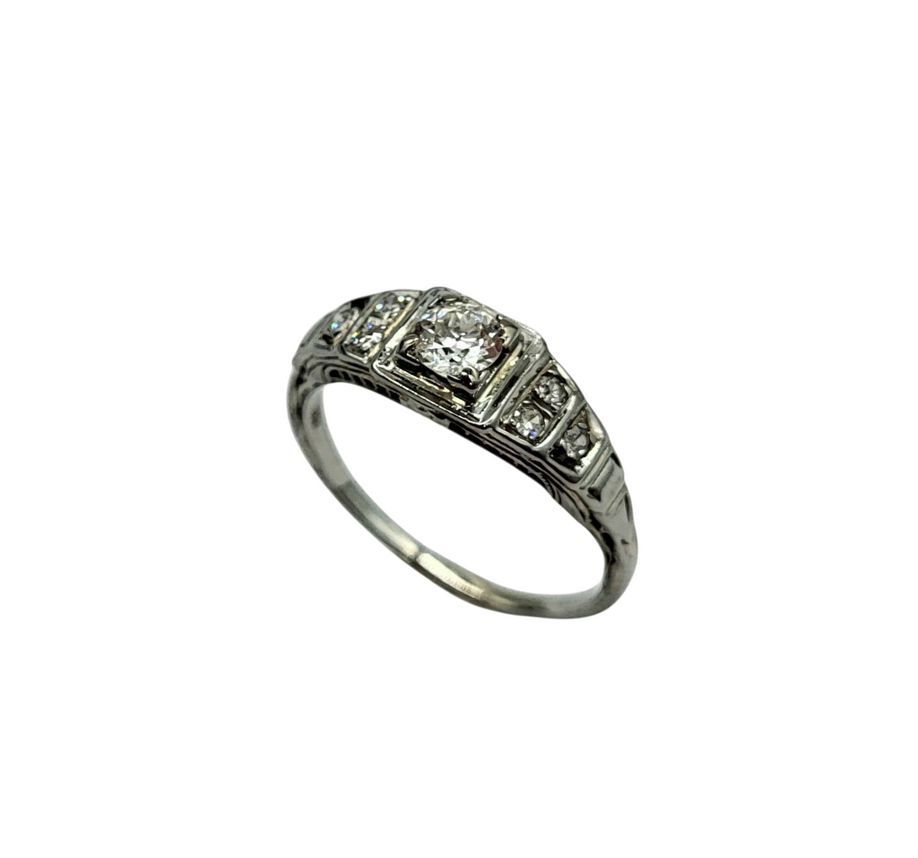 Silver ring with diamonds on a white background