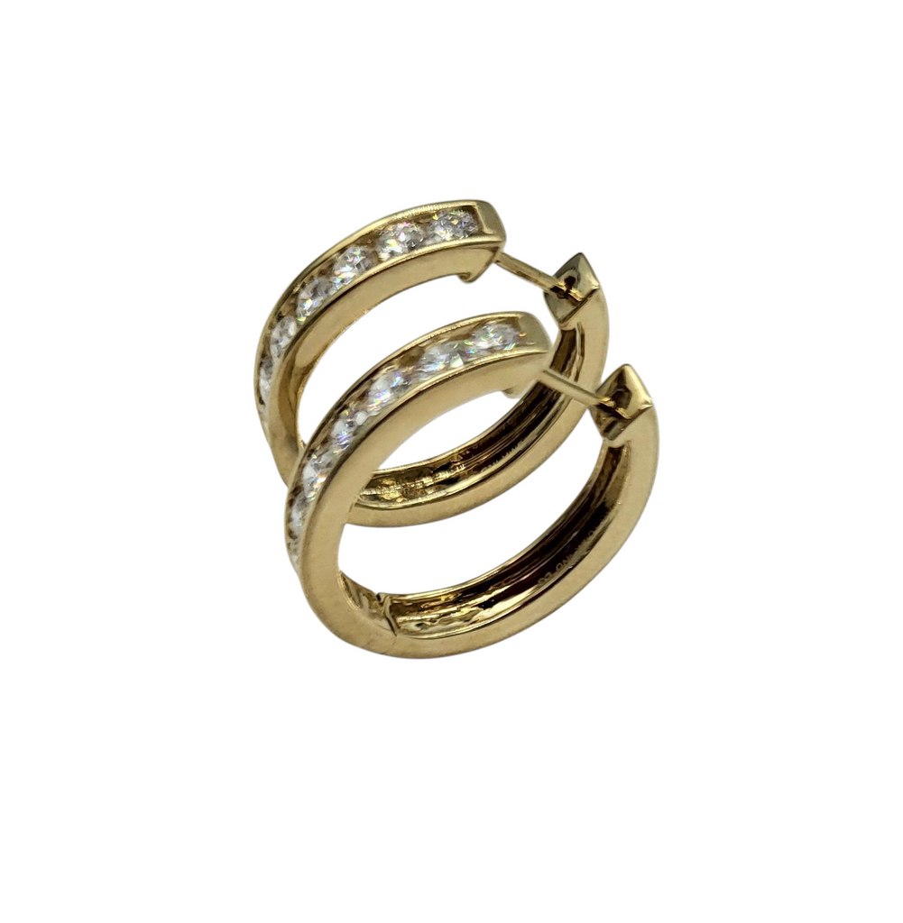 Gold hoop earrings with embedded stones on a white background