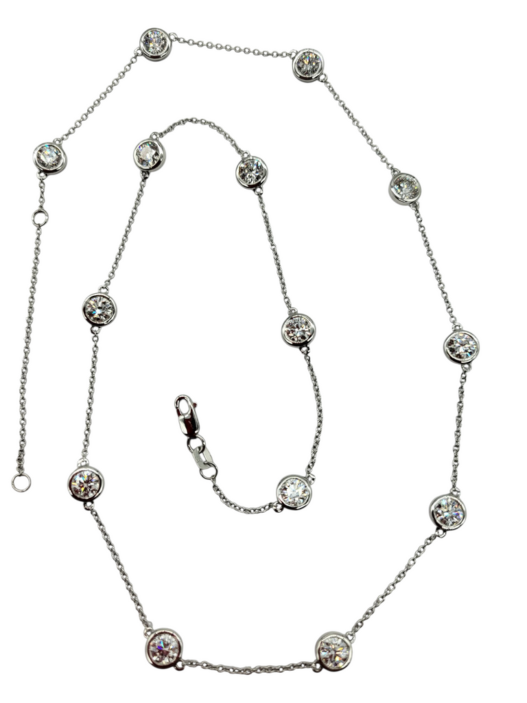 Silver necklace with clear stones on a white background