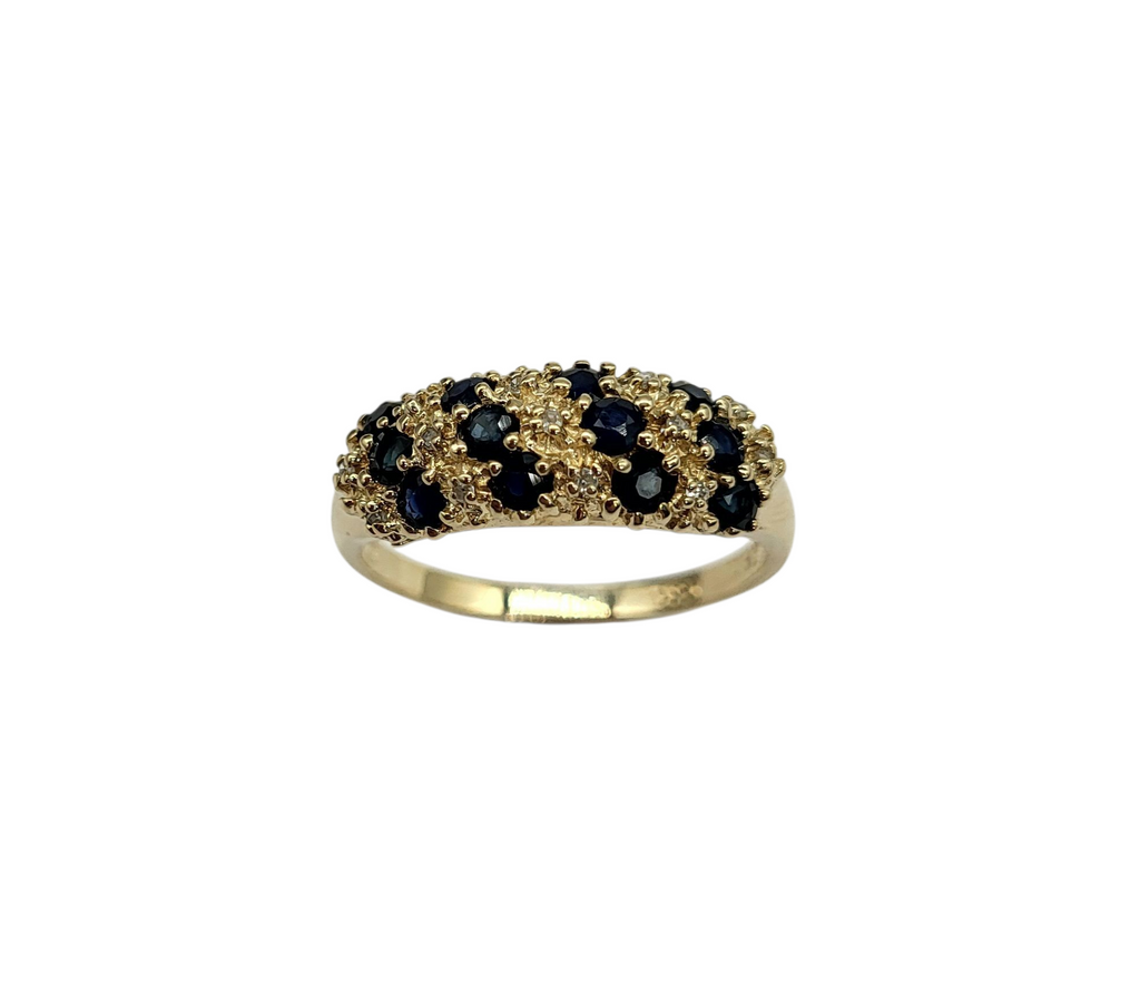 Gold ring with black gemstones on a white background