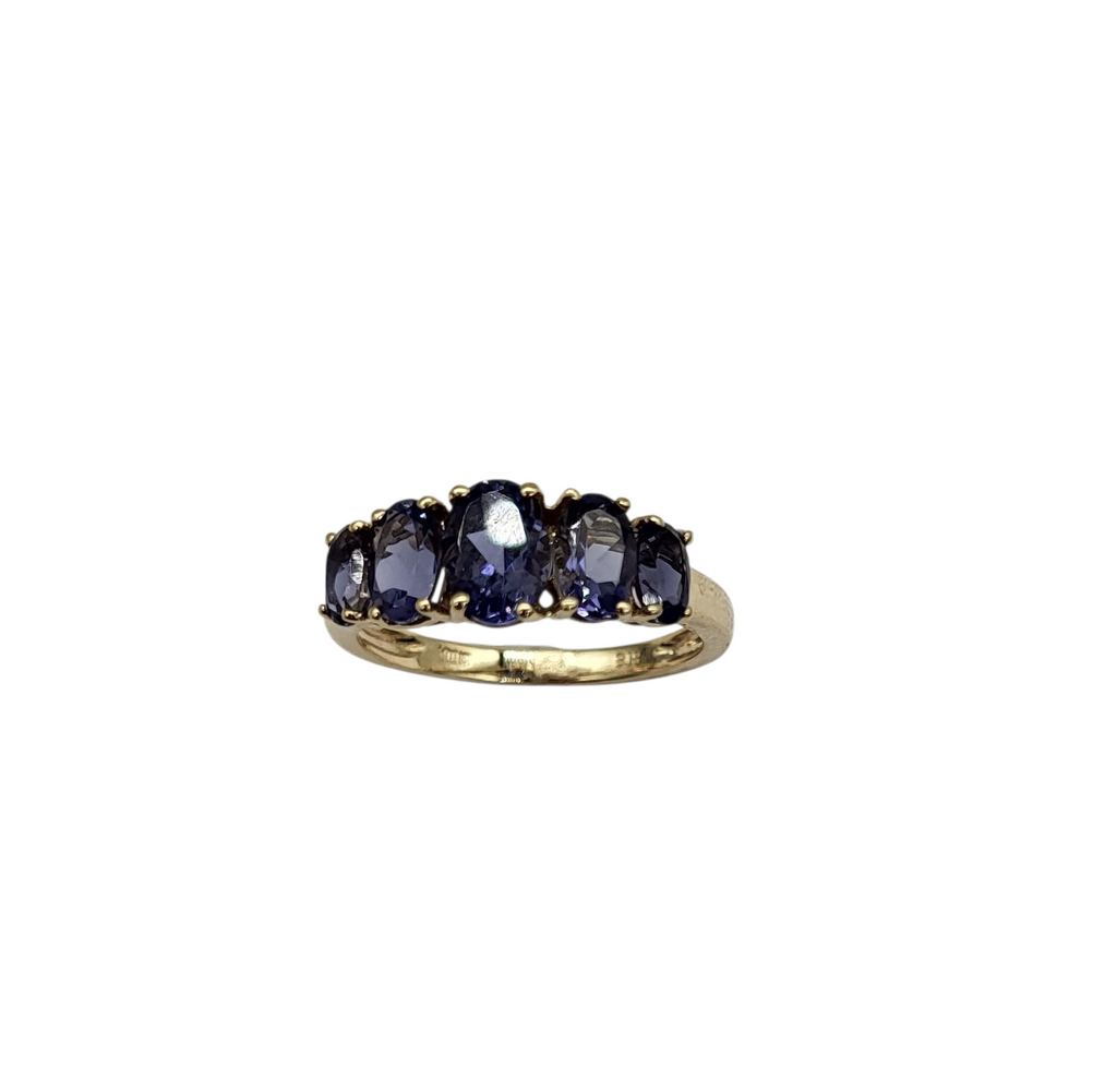 Gold ring with purple gemstones on a white background