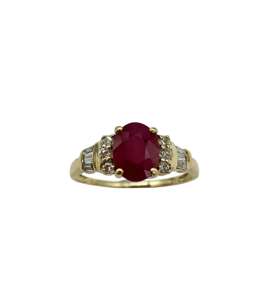 Gold ring with a red gemstone and smaller diamonds on a white background