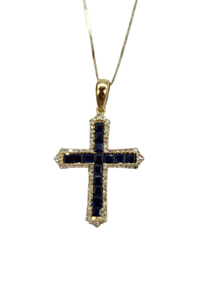 Gold cross pendant with black gemstones on a white background