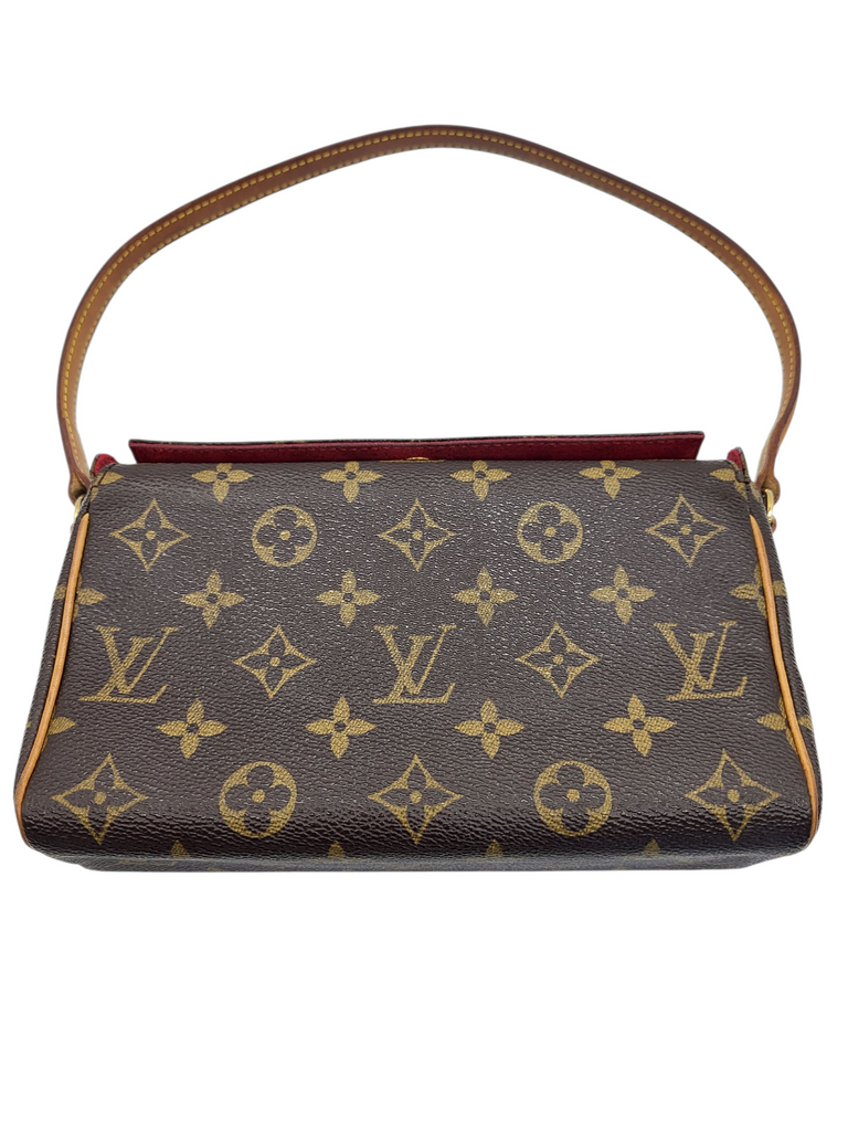 Designer handbag with monogram pattern on a white background